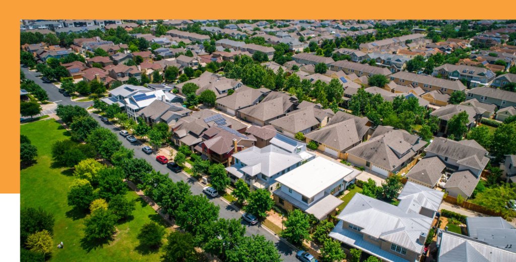 An aerial view of a vibrant residential community with mature trees providing shade and natural beauty.