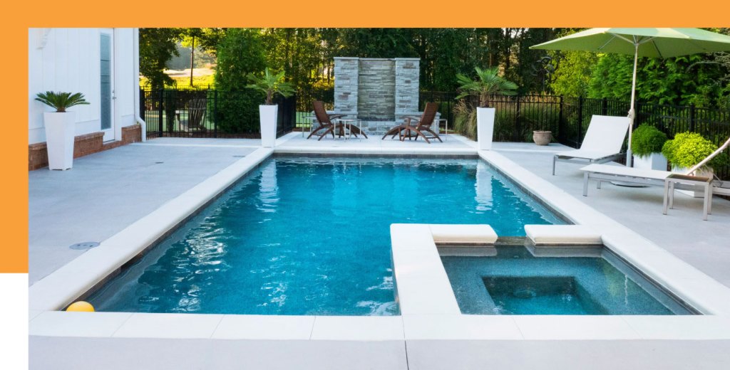 A luxurious backyard pool with a sleek patio, modern lounge chairs, and lush greenery for a serene retreat.